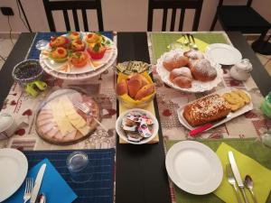 a table topped with plates of pastries and desserts at B&B La Terrazza in Mantova