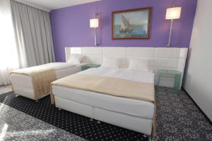 Postel nebo postele na pokoji v ubytování Hotel Phoenix