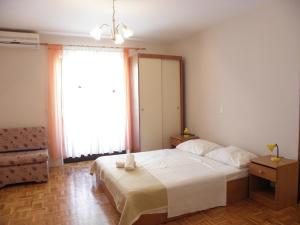 Postel nebo postele na pokoji v ubytování Apartments Katarina