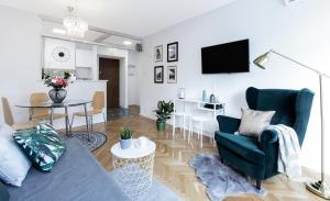 a living room with a couch and a dining room at Warsawrent Apartamenty Centralna in Warsaw