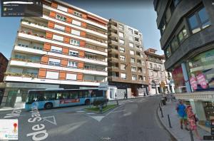 a bus is parked on a street in front of a building at Apartamento Casa Palabra in Santander