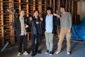 a group of four men posing for a picture at Guest House Minato in Miyako