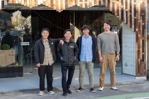 a group of four men standing in front of a store at Guest House Minato in Miyako