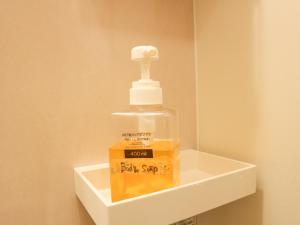 a bottle of water sitting on top of a shelf at Guest House Minato in Miyako