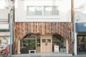 a store front with a wooden facade at Guest House Minato in Miyako