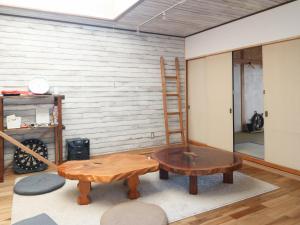 a room with a ladder and a table and a chair at Guest House Minato in Miyako