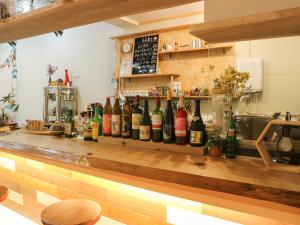 a bar with a bunch of bottles of wine at Guest House Minato in Miyako