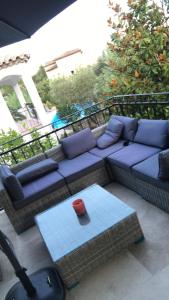 a living room with a couch and a table at Maxima Sunset in Sainte-Maxime