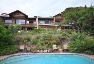 a house with a swimming pool in front of a house at IRONWOOD LODGE in Pennington