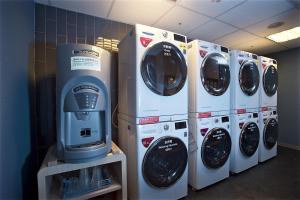 four washers and dryers are lined up in a room at Just Sleep - Ximending in Taipei