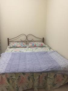 a bed with a quilt on it in a room at Sri Nabalu Apartment Platinum Putatan in Kota Kinabalu