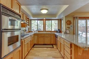 a kitchen with wooden cabinets and granite counter tops at 10 Yellow Rail in Sunriver