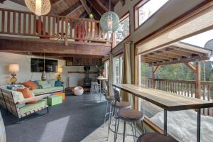 a living room with a table and some chairs at Flying Stag: Upper Chalet in Government Camp