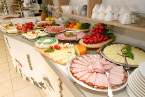 a buffet filled with different types of food on a counter at Hotel Rosmann in Reifnitz