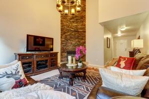 a living room with a couch and a tv at Oaks at Wasatch #5 in Cottonwood Heights
