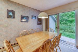 a dining room with a wooden table and chairs at The Woods: Townhouse-F3 in Killington