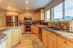 a kitchen with wooden cabinets and stainless steel appliances at Oaks at Wasatch #5 in Cottonwood Heights
