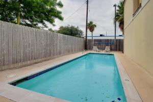 a swimming pool in front of a fence at Golden Gate Getaway in South Padre Island
