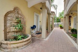a building with a stone fountain in a courtyard at Golden Gate Getaway in South Padre Island