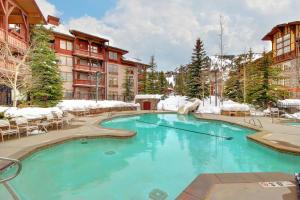 a swimming pool in a resort with snow at Powderhorn Lodge 408: Rustic Mountain Suite in Solitude