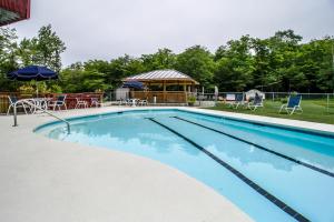 a swimming pool with a gazebo and tables and chairs at Sunrise: West Glade-J2 in Killington