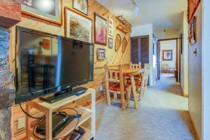 a living room with a television and a dining room at Slopeside Paradise at Axtel in Mount Crested Butte