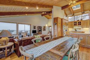 a kitchen and dining room with a large wooden table at Brammer's Bluff in Sea Ranch