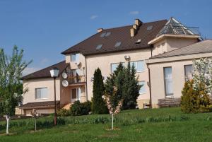 a large house with a yard in front of it at Guest House Uzhgorod in Uzhhorod