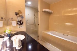 a bathroom with a tub, toilet and sink at Kinta Riverfront Hotel & Suites in Ipoh