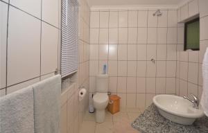 a bathroom with a toilet and a sink at IRONWOOD LODGE in Pennington
