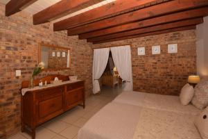 a bedroom with a sink and a brick wall at IRONWOOD LODGE in Pennington