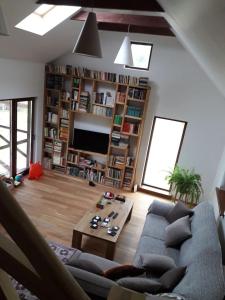 a living room with a couch and a table at Kauzeri - home while away from home in Vildoga