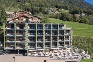 an aerial view of a hotel in the mountains at Oliven- & Genusshotel Hirzer in Schenna