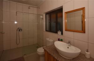 a bathroom with a sink and a toilet and a shower at IRONWOOD LODGE in Pennington