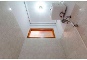 a bathroom with a shower with a window at Embe Enem Homestay in Yogyakarta +53 photos