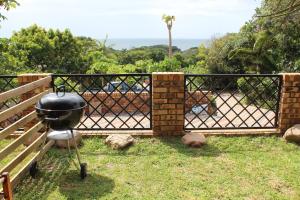 a grill on a fence in a yard at IRONWOOD LODGE in Pennington