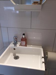a bathroom sink with a bottle of soap on it at Zimmer nahe Messe und Flughafen in Düsseldorf