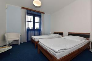 Voodi või voodid majutusasutuse Hotel Trilobit toas