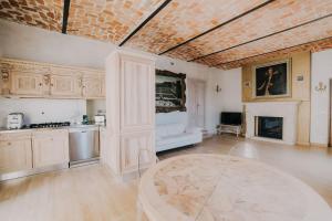 a living room with a table and a fireplace at Casa Luigi Ariano in Santo Stefano Belbo