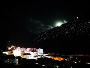 a hill with a light on top of it at night at Kangding Guozhuang Nan Wu Hao Boutique Inn in Kangding