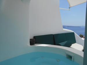 a room with a couch and a view of the water at Rimida Villas- Adults Only in Oia