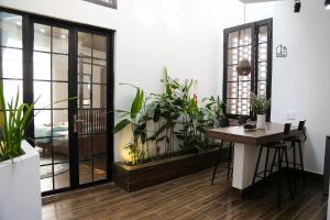 a room with potted plants and a desk in a room at Chaca House in Da Nang