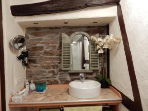 a bathroom with a sink and a stone wall at Haus Mosel-Oase in Cochem