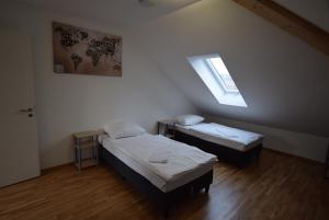 a small room with two beds and a window at AB Kornwestheim in Kornwestheim