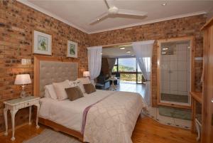 a bedroom with a bed and a brick wall at IRONWOOD LODGE in Pennington +37 photos