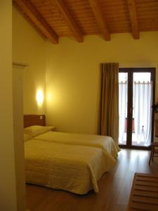 Un pat sau paturi într-o cameră la Bosco Romagno