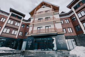 a building with a balcony on top of it at New Gudauri Suites in Gudauri