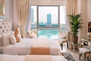a hotel room with a bed and a swimming pool at Elite Royal Apartment - Full Burj Khalifa and Fountain View - Caesar in Dubai