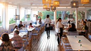 a restaurant with people sitting at tables at Vallicella Glamping Resort in Scarlino +52 photos