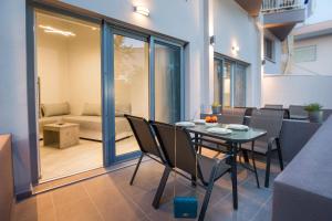 a dining room with a table and chairs and a couch at Mr & Mrs K Lofts in Potos